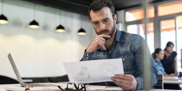 Man looking at Accounting reports for Start up Business