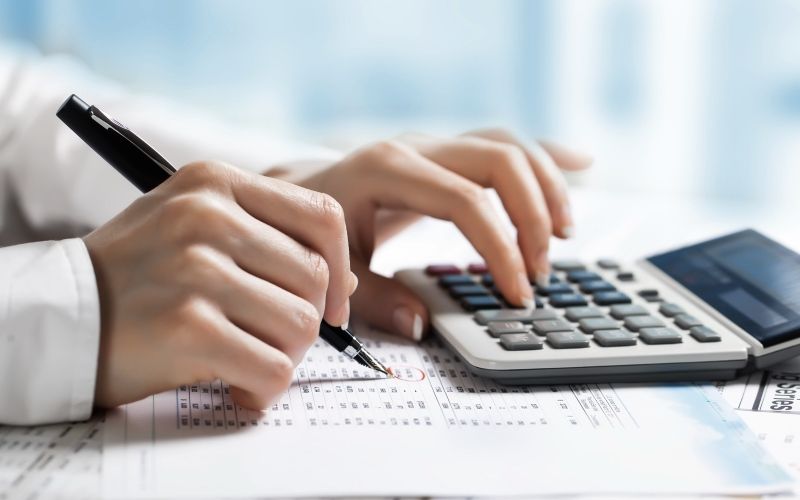 Tax Accountant with hands on calculator, complete booking services for Macksville and mid-north coast businesses